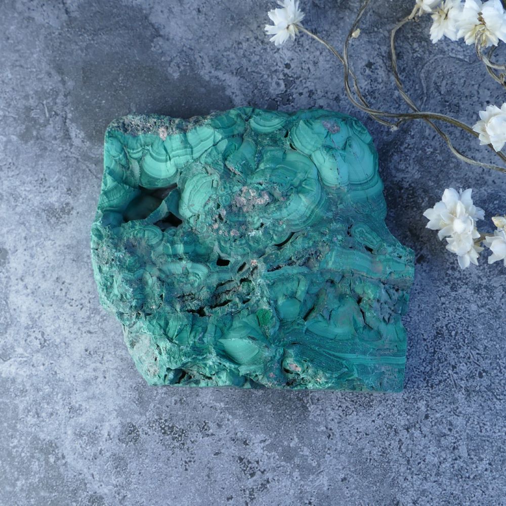 Embrace Change with Dumi's Crystals (8cm x 8.5cm x 1cm). Polished malachite slab reveals vibrant green alongside natural stone. Promotes healing, protection, and spiritual growth.