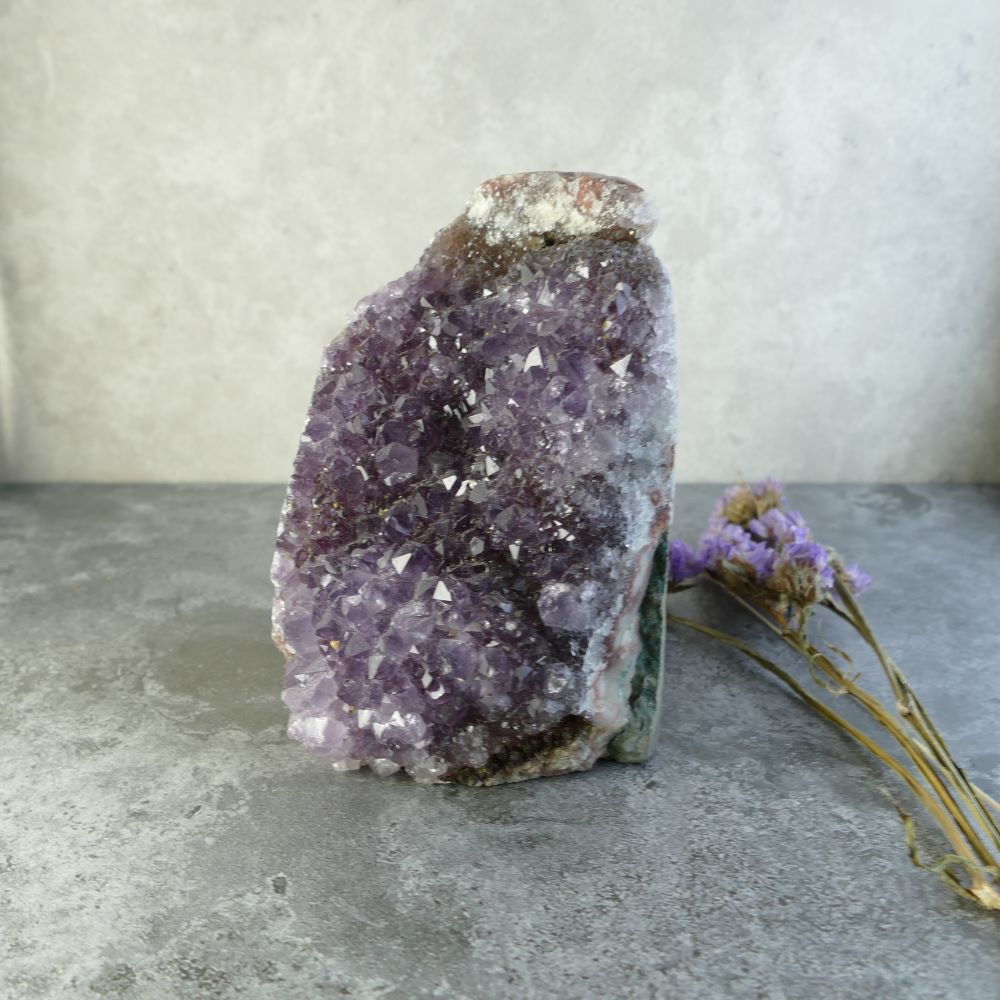 Dazzling amethyst cluster for your crystal collection! This Dumi's Crystals piece measures 4.2 inches tall by 2.5 inches wide by 2.7 inches long and weighs approximately 605 grams.