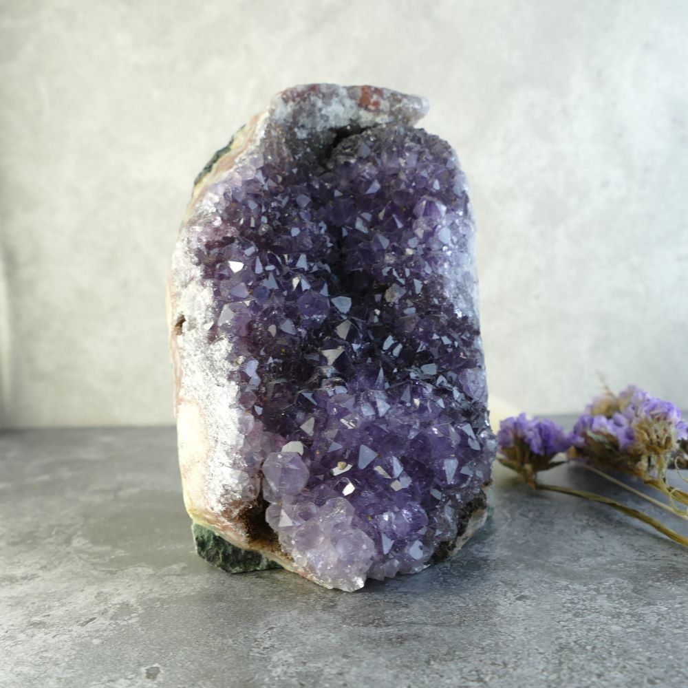 Dumi's Crystals offers a beautiful amethyst cluster. This natural wonder is roughly 4.2 inches high, 2.5 inches wide, and 2.7 inches long, weighing about 605 grams.