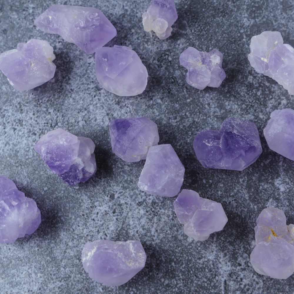 Amethyst Flower chip. This genuine Amethyst crystal displays a soothing purple color and unique floral pattern, known for its healing properties and ability to promote inner peace and spiritual connection.