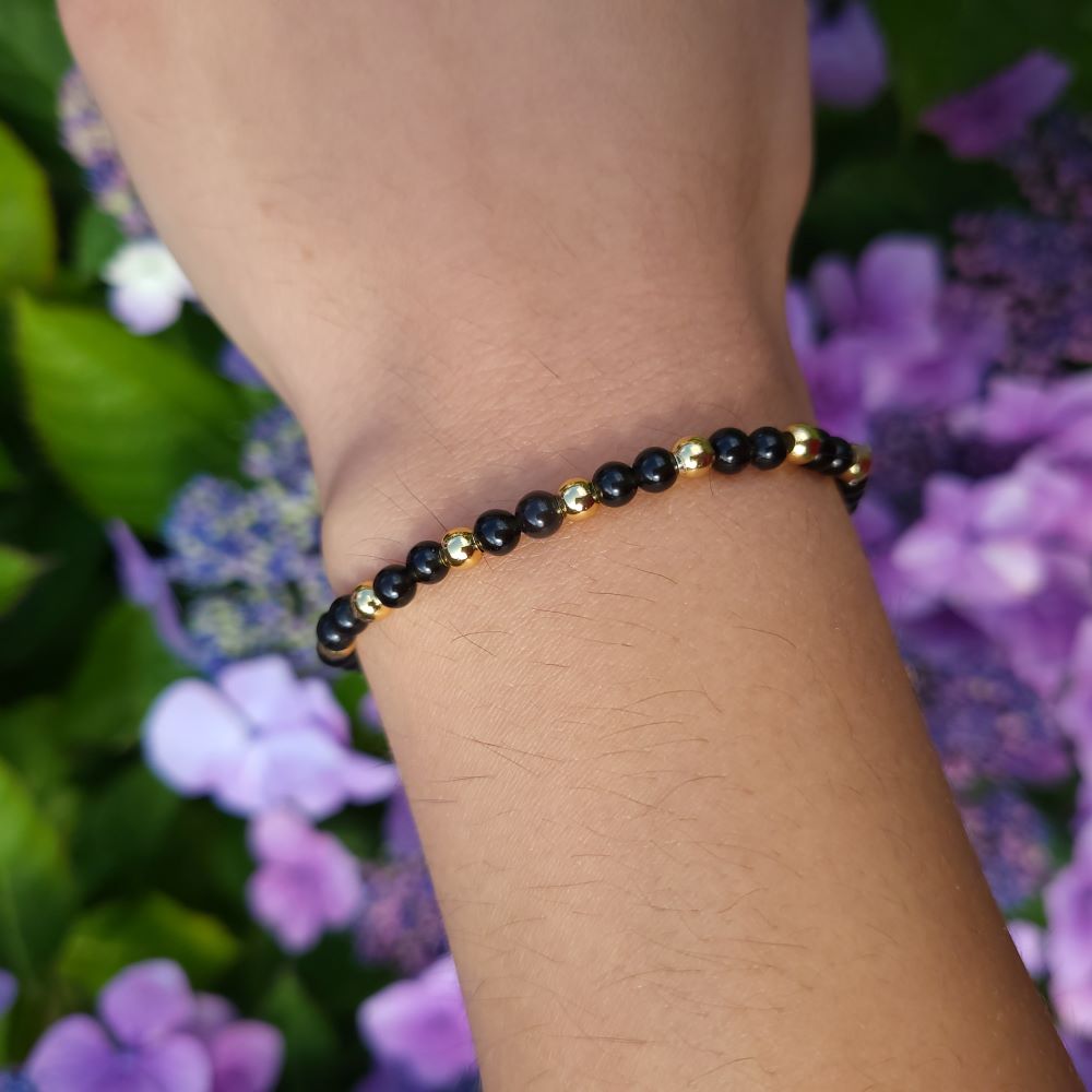 Dumi's Crystals Black Obsidian Bracelet with Gold Accents 7inch for Protection & Strength. Black gemstone bracelet with gold accents for stress relief & grounding. 