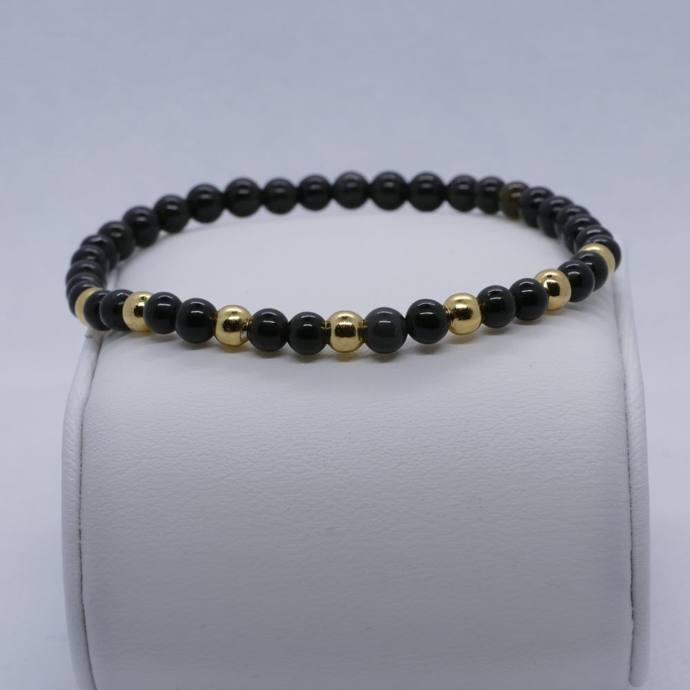 Dumi's Crystals Black Obsidian Bracelet with Gold Accents. Sophisticated style meets protection. Black obsidian beads & gold accents for inner strength. 