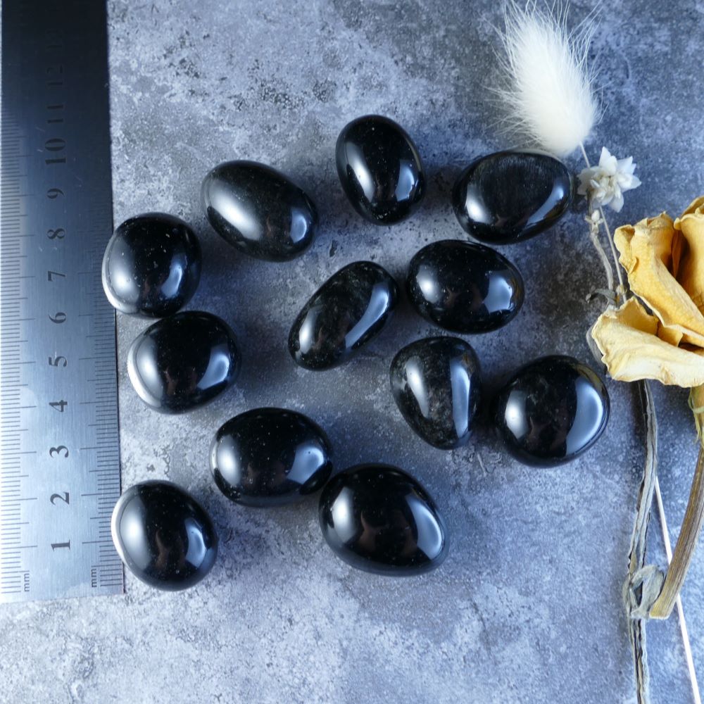 Black Obsidian Crystal Tumbles - Enhance your well-being with Dumi's Crystals' obsidian stones. Polished to a high gloss, these black beauties promote protection, grounding, and positive change.