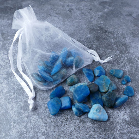 Dumi's Crystals | Blue Apatite Chips Pouch (20g) | A luxurious organza pouch overflowing with Blue Apatite chips, showcasing their deep blue hues and variations in size. Blue Apatite is known for its ability to enhance motivation, clarity, and creative inspiration.