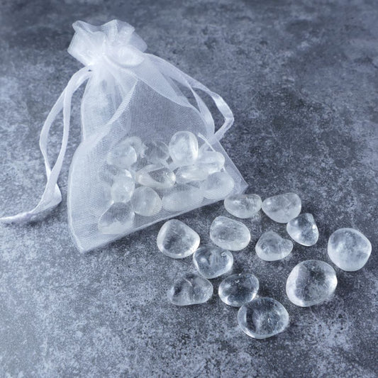 Dumi's Crystals | Clear Quartz Chips Pouch (20g) | A luxurious organza pouch overflowing with Clear Quartz chips, showcasing their crystal clarity and variations in size. Clear Quartz is known as the Master Healer, promoting healing, clarity, and energy purification.