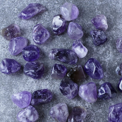 Dumi's Crystals | Dark Amethyst Chips (20g) | A collection of genuine Dark Amethyst chips in various shades of deep purple. Amethyst is known for its calming energy and ability to promote stress relief, peace, and spiritual protection. These chips typically range from 1 to 1.5 centimetres.
