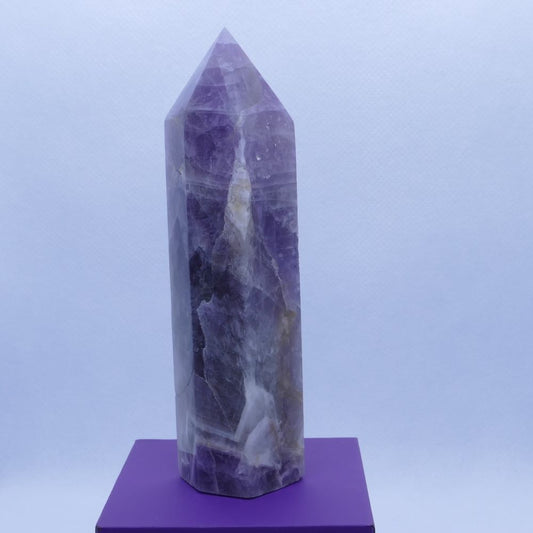 purple amethyst and white quartz tower on a purple box and white background 