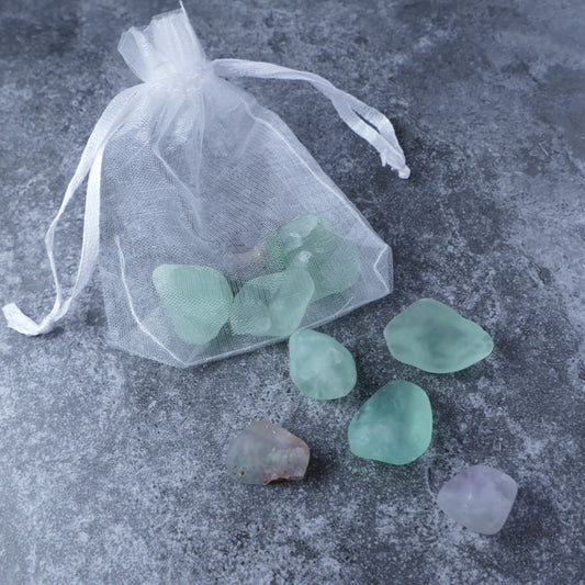 Dumi's Crystals | Fluorite Chips Pouch (20g) | A luxurious organza pouch overflowing with Fluorite chips, showcasing their vibrant array of colors. Fluorite is known for its revitalizing energy, promoting mental focus, emotional balance, and inner peace.