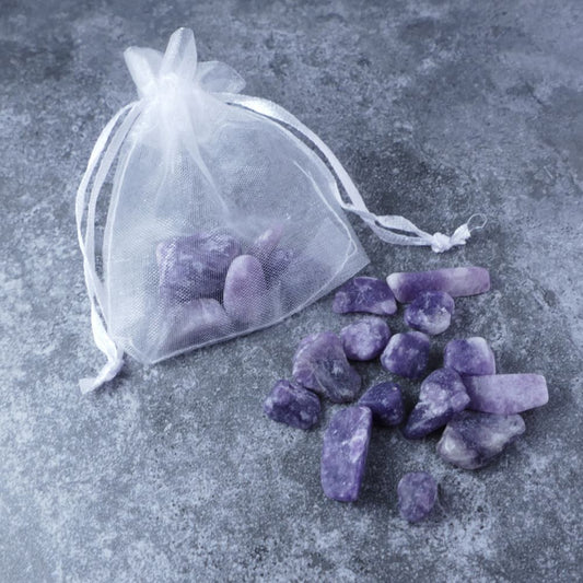 Dumi's Crystals | Lepidolite Chips Pouch (20g) | A luxurious organza pouch overflowing with Lepidolite chips, showcasing their delicate lilac hues. Lepidolite is known as a stone of peace and emotional balance, promoting relaxation, stress relief, and inner harmony.
