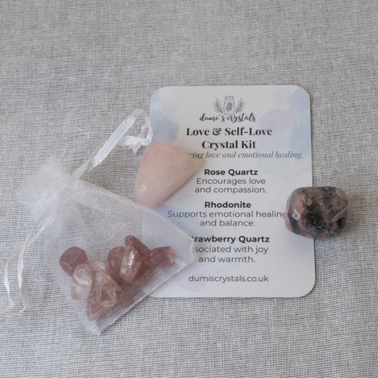 Crystal kit with rose quartz, rhodonite, and strawberry quartz on a gray background