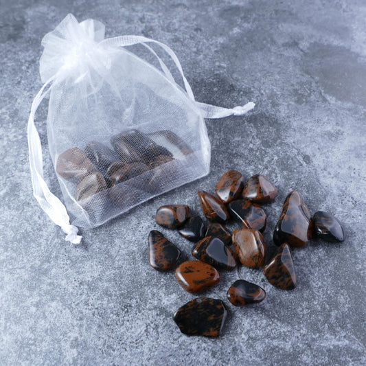 Dumi's Crystals | Mahogany Obsidian Chips Pouch (20g) | A luxurious organza pouch overflowing with Mahogany Obsidian chips, showcasing their deep, rich hues. Mahogany Obsidian is known as a protective and grounding stone, promoting spiritual growth, stability, and a sense of security.