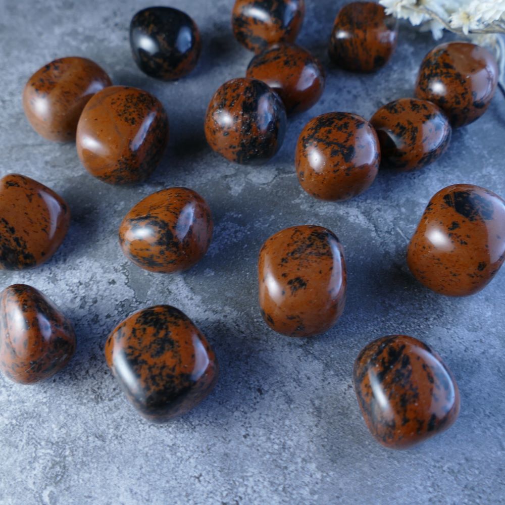 Mahogany Obsidian Crystal Tumbles - Unleash the Earth's Strength! Dumi's Crystals offers exclusive Mahogany Obsidian (2-2.5cm, 9-15g). Known for its grounding and protective properties.