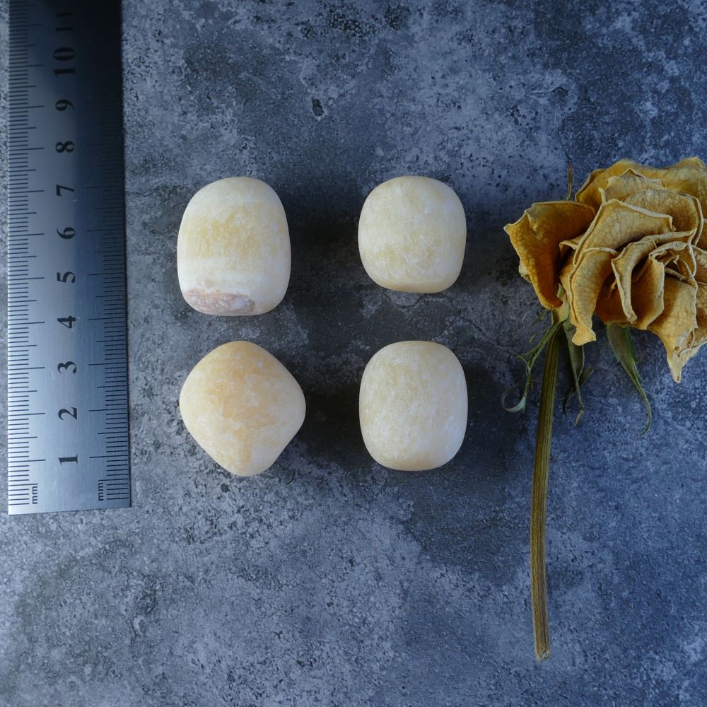 Dumi's Crystals - Orange Calcite Tumbled Stones - A burst of sunshine for your spirit! Bright orange stones (1.5-2.5cm) come in various sizes (10-20g or 20-30g) and promote creativity and positivity.