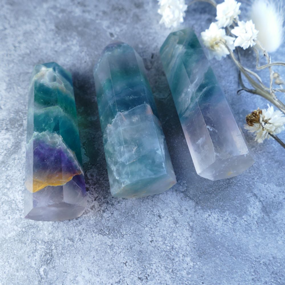 Fluorite Tower with Rainbow Hues - This polished fluorite tower features a stunning array of colors, believed to enhance creativity, reduce stress, and promote mental well-being.