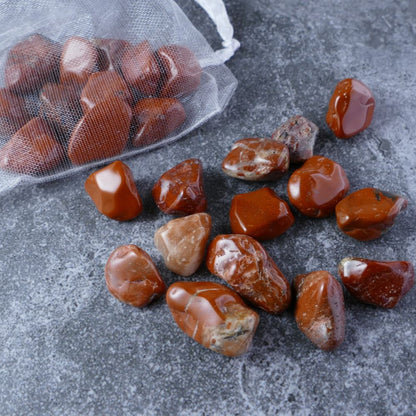 Dumi's Crystals | Red Jasper Chips (1-1.5cm) | Close-up of a collection of genuine Red Jasper chips, highlighting their captivating red color and variations in texture. Red Jasper is revered for its ability to ignite inner fire, bolster strength, and promote a sense of vitality.