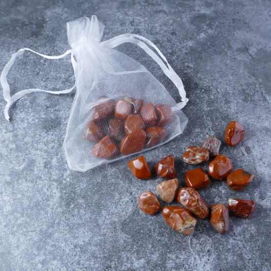 Dumi's Crystals | Red Jasper Chips Pouch (20g) | A luxurious organza pouch overflowing with Red Jasper chips, showcasing their deep red hues. Red Jasper is known for its invigorating energy, promoting strength, vitality, and a fiery passion for life.
