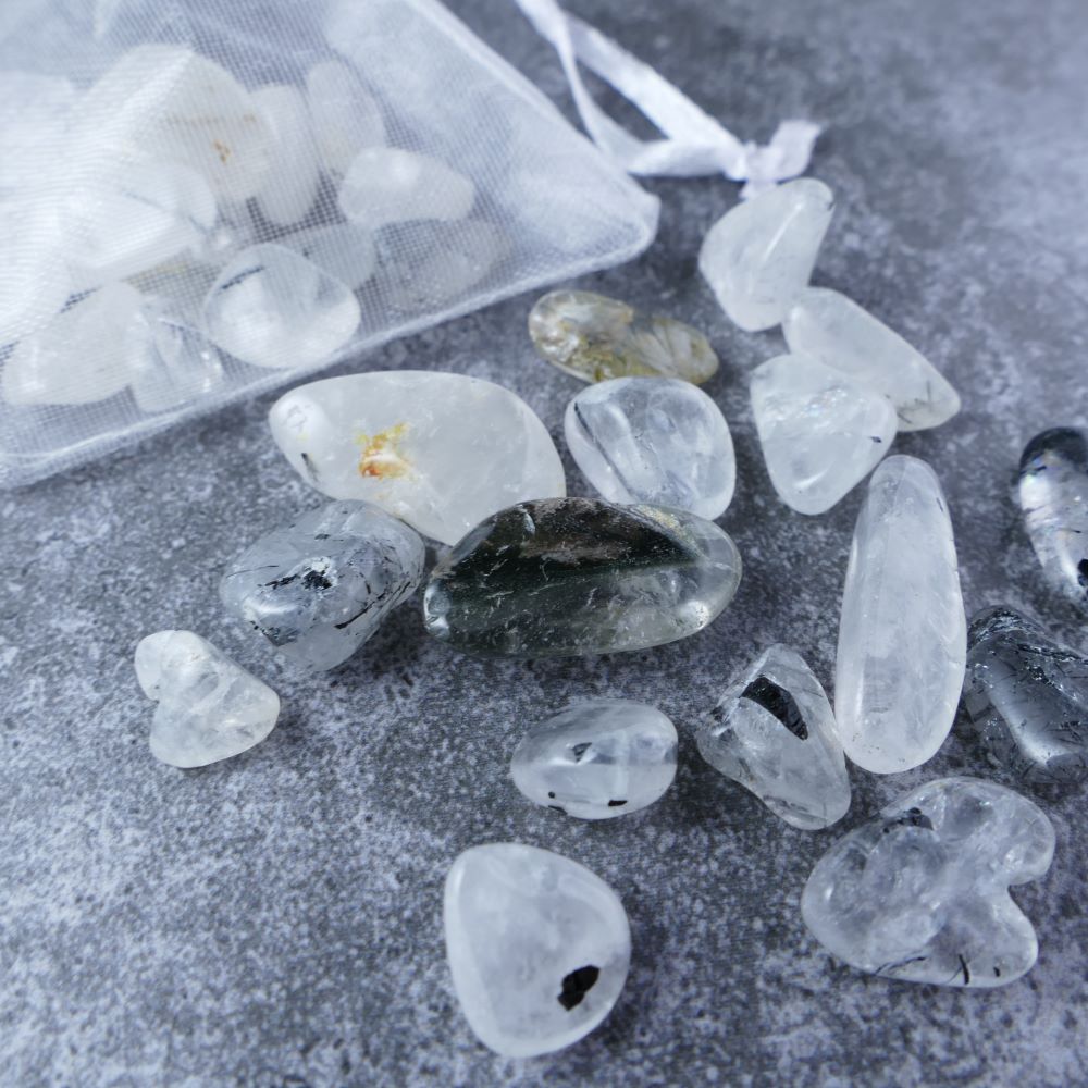 Dumi's Crystals | Rutilated Quartz Chips (1-1.5cm) | Close-up of a collection of genuine Rutilated Quartz chips, highlighting their golden rutile inclusions and variations in size and color. Rutilated Quartz is revered for its ability to promote clarity, spiritual growth, and emotional balance.