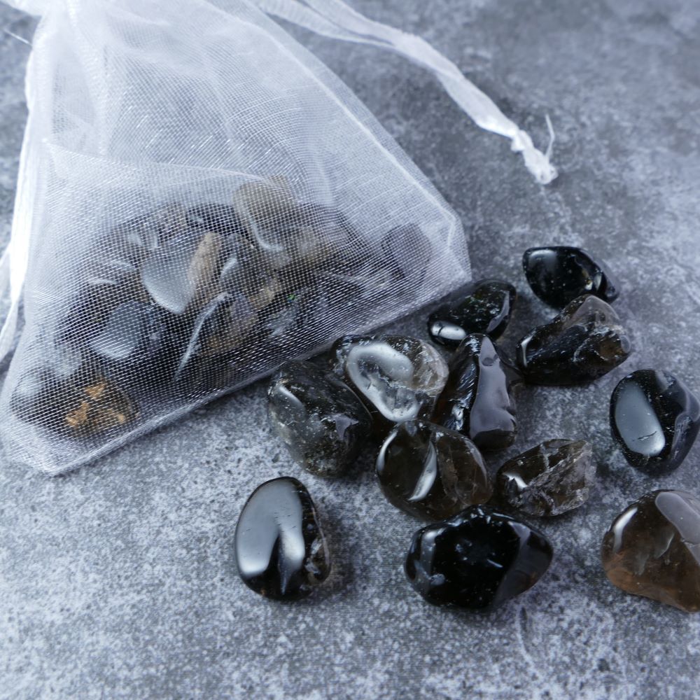 Dumi's Crystals | Smoky Quartz Chips (1-2.5cm) | Close-up of a collection of genuine Smoky Quartz chips, highlighting their smoky hues and variations in translucency. Smoky Quartz is revered for its ability to cleanse negativity, promote emotional clarity, and foster a sense of peace.