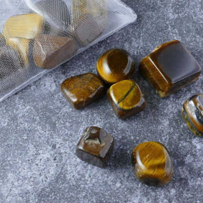  Dumi's Crystals | Tiger's Eye Chips (1-2.5cm) | Close-up of a collection of genuine Tiger's Eye chips, highlighting their mesmerizing golden color and banded patterns. Tiger's Eye is revered for its ability to boost confidence, ignite inner strength, and offer protection.