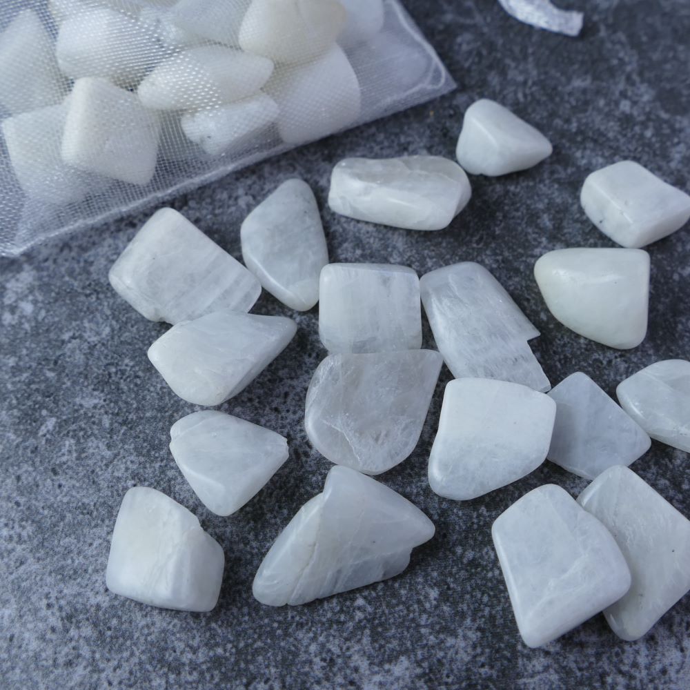 Dumi's Crystals | White Moonstone Chips (1-2.5cm) | Close-up of a collection of genuine White Moonstone chips, highlighting their soft white hues and variations in texture. White Moonstone is revered for its ability to enhance intuition, emotional balance, and spiritual growth.