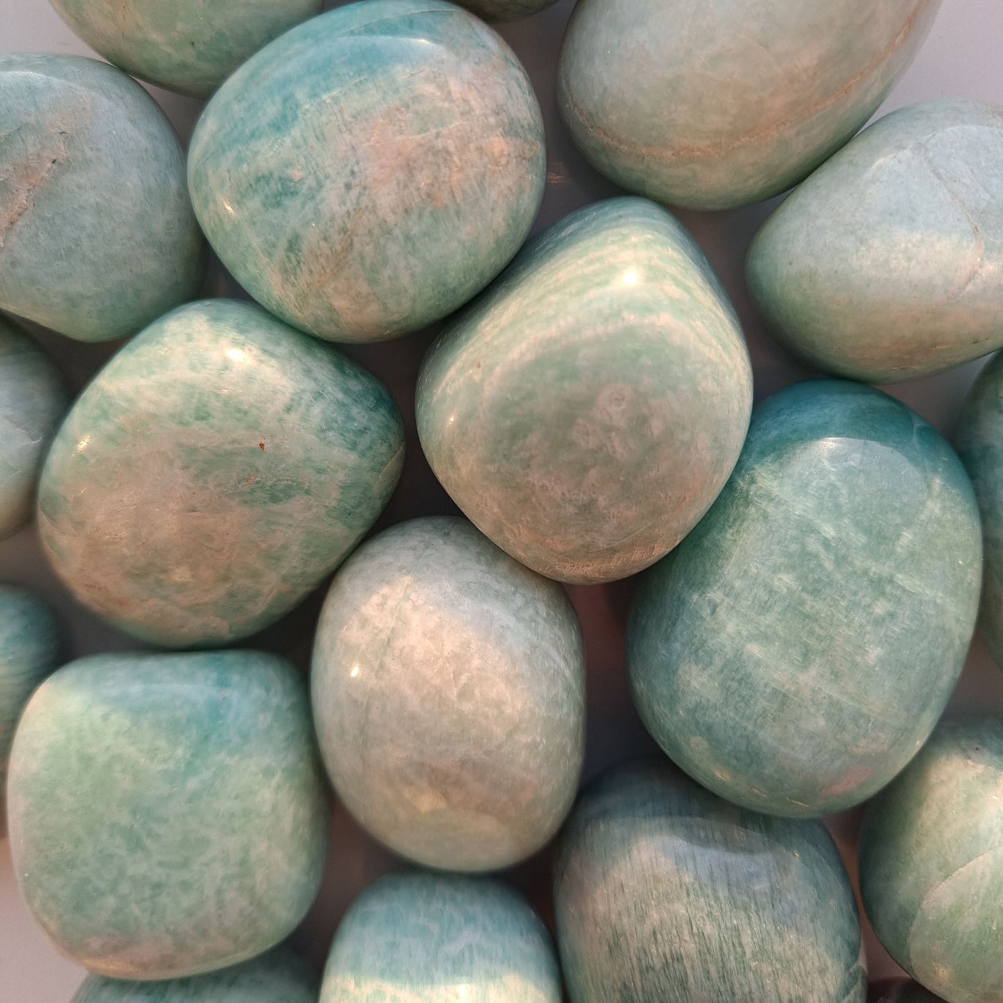 Dumi's Crystals | Amazonite Tumbled Stones (Multiple) | A collection of beautiful Amazonite Tumbled Stones, varying in size and shape. Amazonite is known for its tranquil blue-green hues and its ability to promote peace, balance, and inner truth.