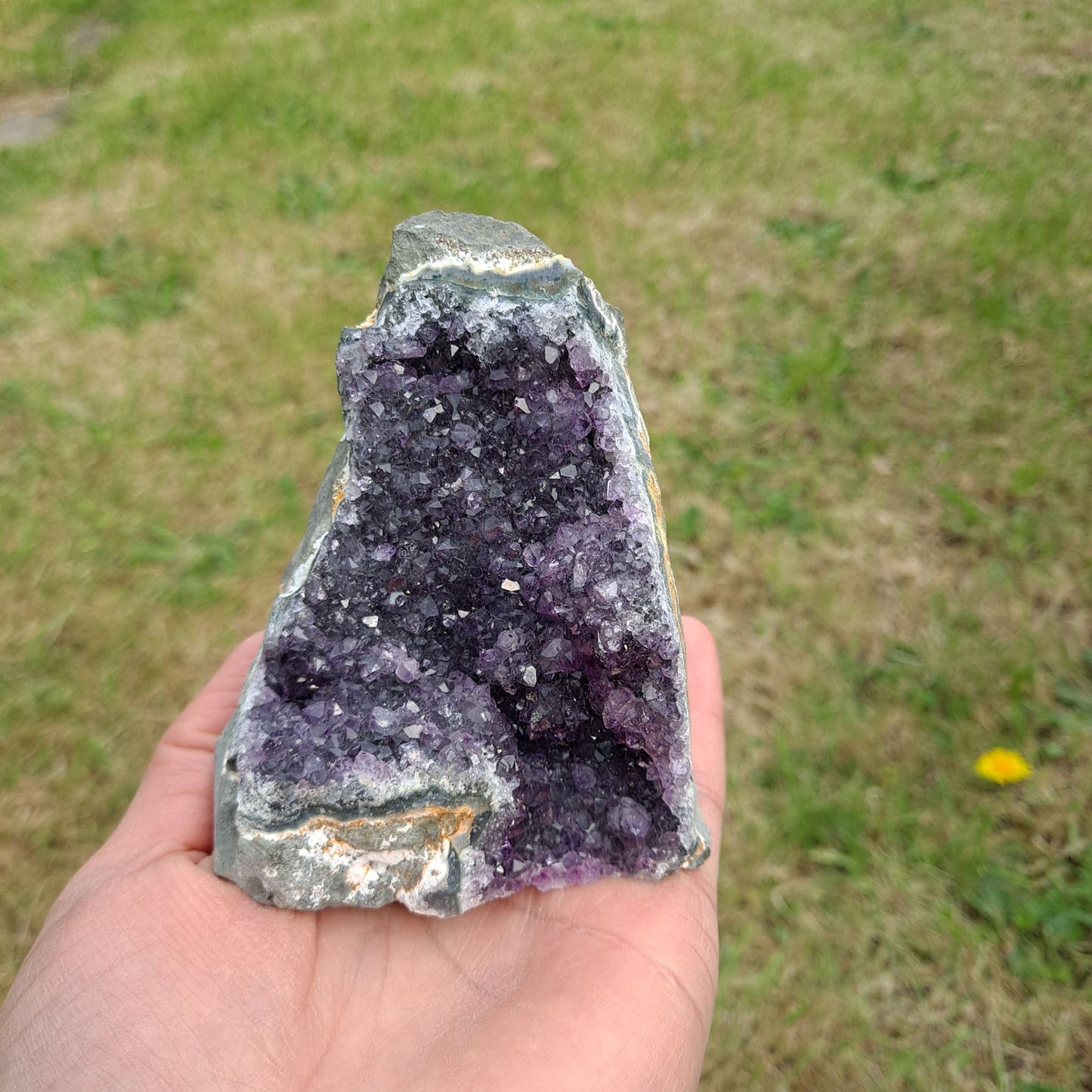 Dumi's Crystals | Amethyst Cluster (Portable, 9cm) held in hand | Hold the calming energy of Amethyst in your palm. This Amethyst Cluster (9 x 7.6 x 7.6cm) is perfect for meditation or carrying with you throughout the day to promote peace and focus.