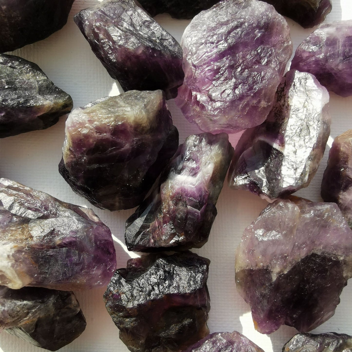 Dumi's Crystals | Rough Amethyst Crystals (Peace & Wisdom) | A collection of Rough Amethyst Crystals, each a reminder of the untamed spirit within. Rough Amethyst fosters tranquility, reduces stress & enhances spiritual awareness. Scatter them in your home or workspace to create a space overflowing with protective energy and a sense of inner wisdom.