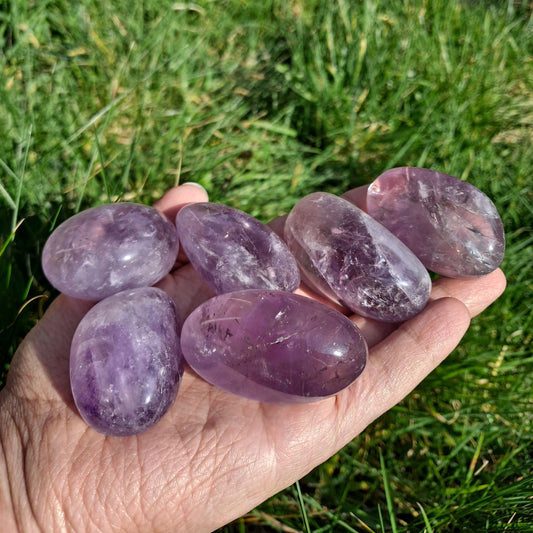  Dumi's Crystals | Amethyst Tumbled Stones (Peace & Clarity) | A handful of Amethyst Tumbled Stones, each a captivating display of deep purple hues. Amethyst is believed to promote peace, clarity, and spiritual growth. Hold them during meditation or carry them with you throughout the day.