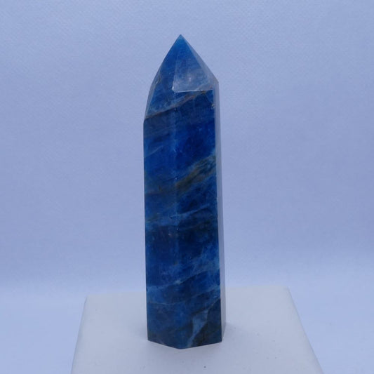 blue apatite tower healing crystal on a white box and white background, seller is dumi's crystals