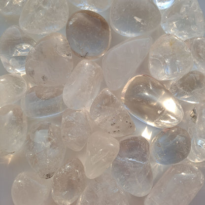 Dumi's Crystals | Clear Quartz Tumbled Stones (Sparkling Potential) | A collection of Clear Quartz Tumbled Stones, each a testament to nature's beauty. Renowned as the "master healer," Clear Quartz cleanses negativity and amplifies positive energy. Scatter them in your home or workspace to create an uplifting and harmonious atmosphere.
