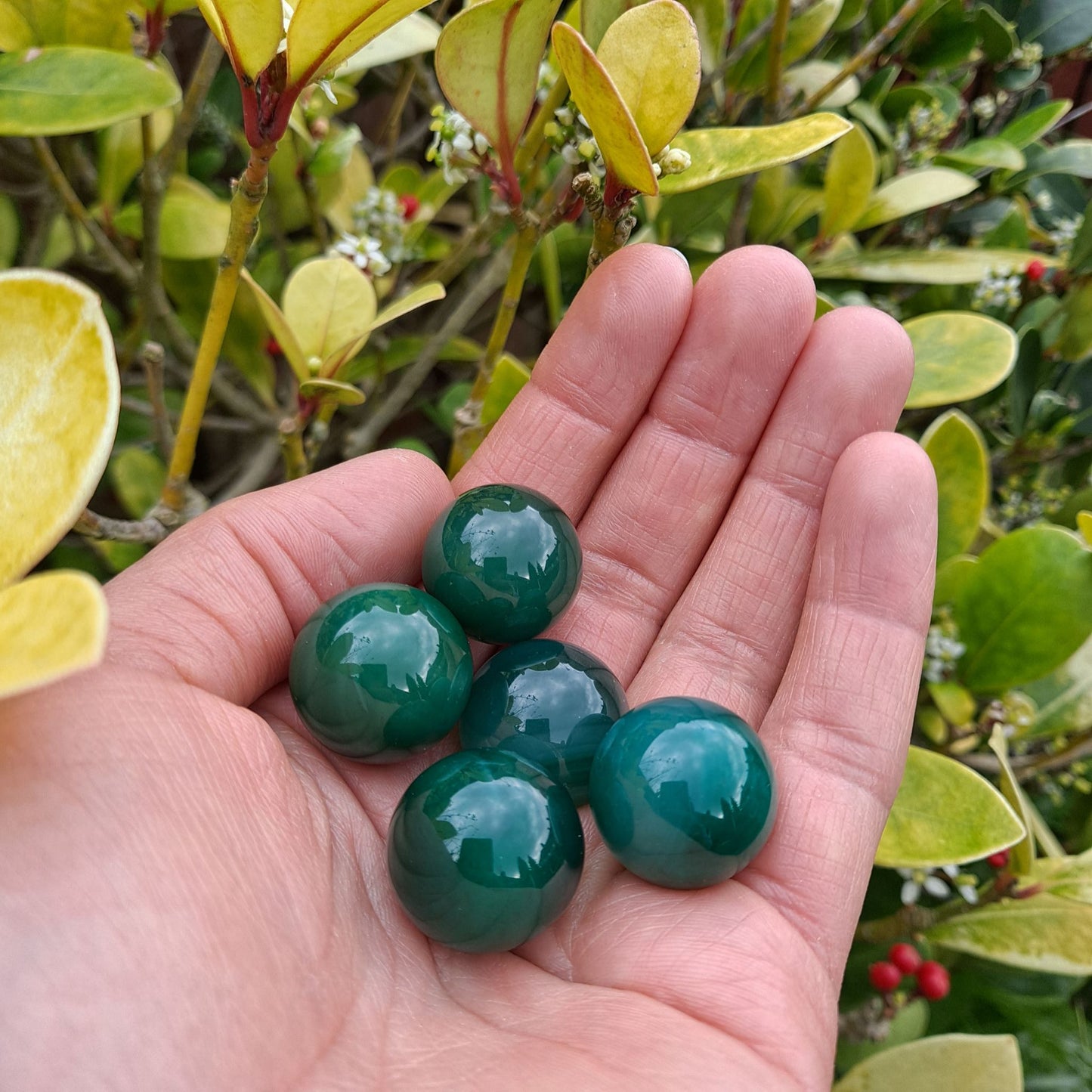 Dumi's Crystals | Green Agate Mini Spheres (20mm) | A collection of captivating Green Agate Mini Spheres, each displaying a unique variation of green hues and patterns. These 20mm spheres are believed to promote peace, emotional balance, personal growth, and a connection with nature. Perfect for meditation, crystal grids, or carrying with you throughout the day.