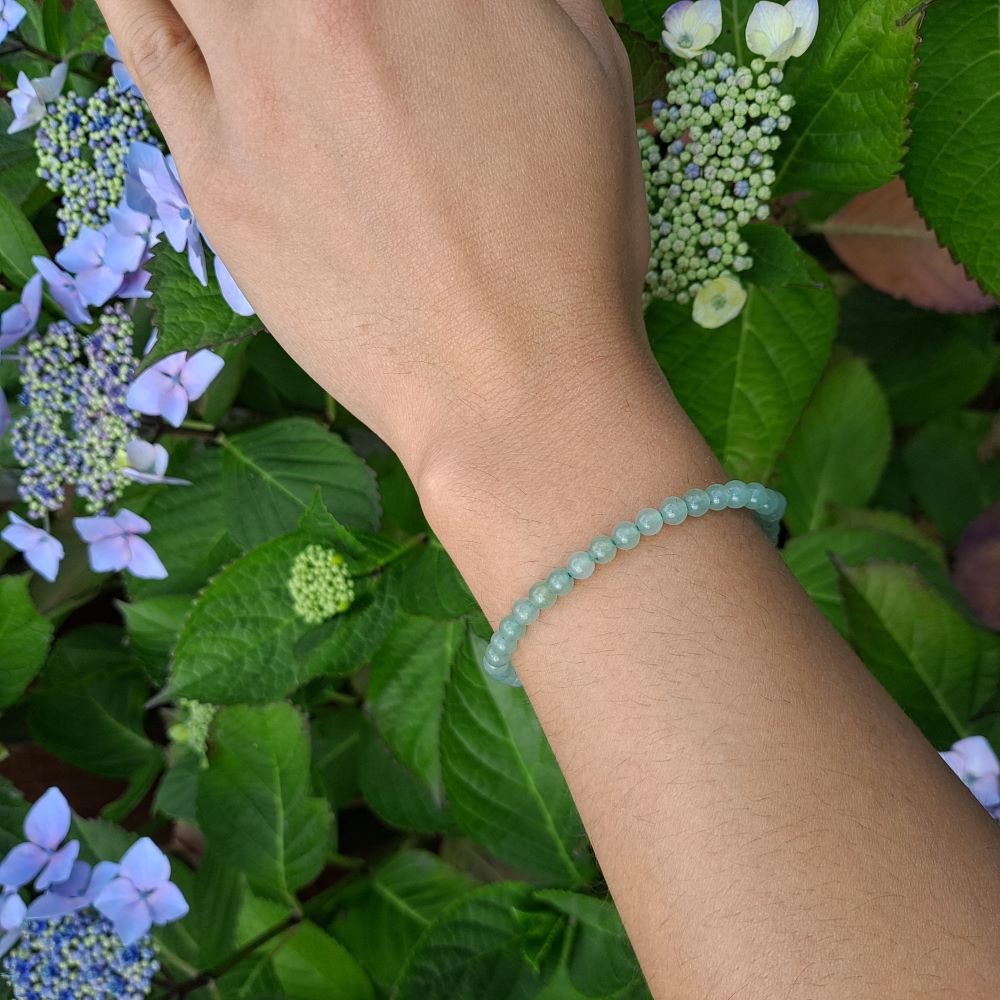 Dumi's Crystals | Green Aventurine Stretch Bracelet (4mm) | Showcasing the calming green hues of Green Aventurine on a wrist. This bracelet features genuine Green Aventurine beads, known for their connection to the heart chakra. Green Aventurine promotes peace, abundance, and personal growth.