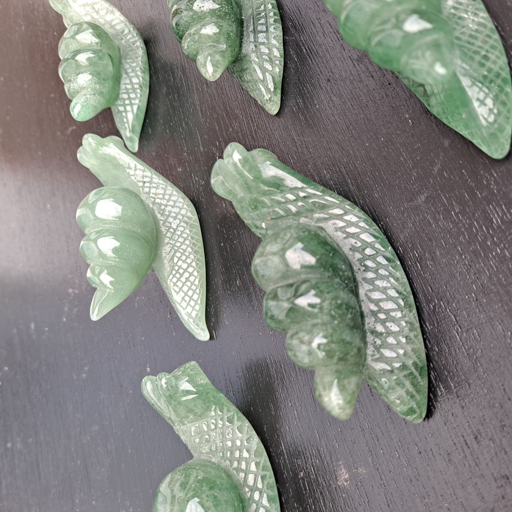 Dumi's Crystals | Green Aventurine Snail Carving (Serene Guidance): A close-up of a Green Aventurine Snail Carving, showcasing its intricate details and mesmerizing green hues. Hand-carved from Green Aventurine, this symbol of patience & steady progress radiates serene guidance. Embrace calmness & abundance with Dumi's Crystals (ethically sourced).