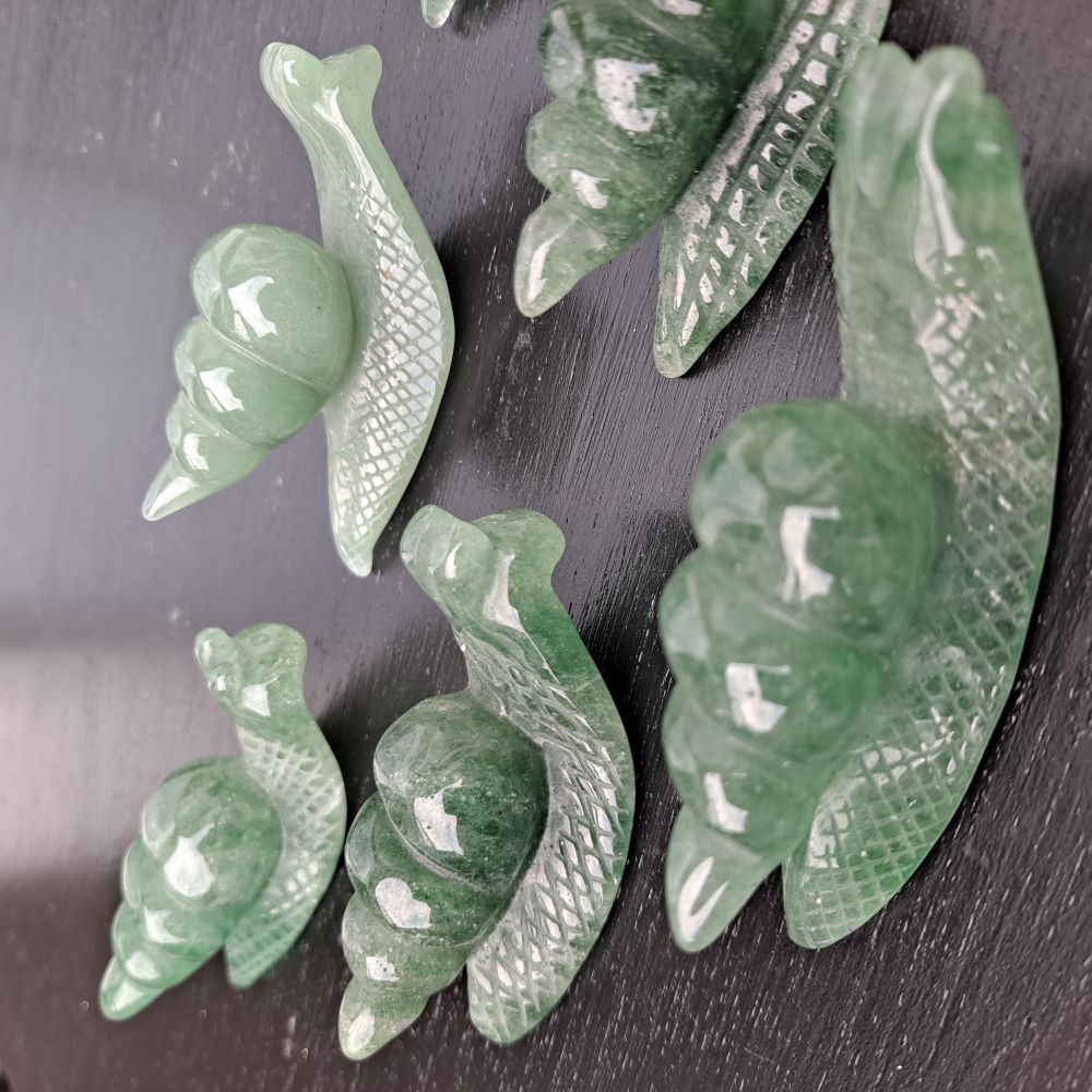 Dumi's Crystals | Green Aventurine Snail Carving (Positive Persistence): A Green Aventurine Snail Carving, a symbol of patience and positive persistence. Hand-carved with captivating green hues, this snail promotes emotional balance & attracts abundance. Invite its calming energy into your life with Dumi's Crystals (ethically sourced).