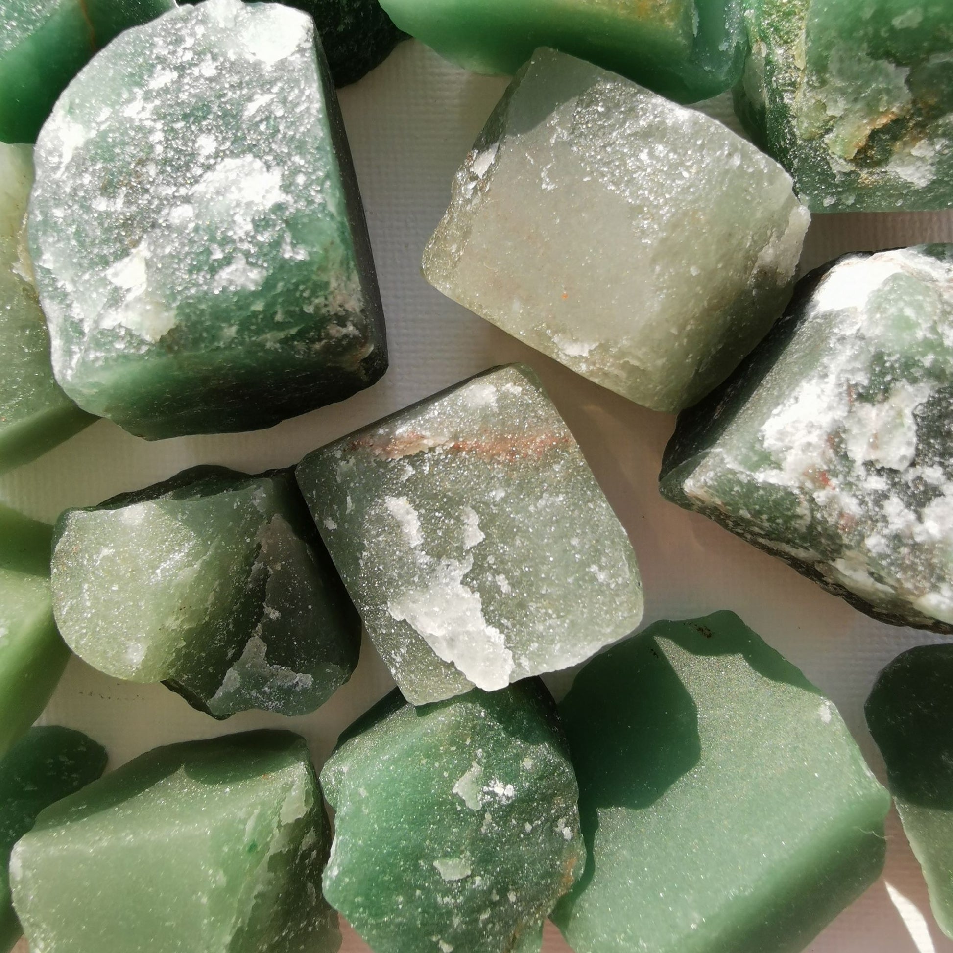Dumi's Crystals | Rough Green Aventurine Crystals (Opportunity & Harmony) | A collection of Rough Green Aventurine Crystals, reminders of your potential for abundance. Green Aventurine fosters opportunity, reduces negativity & promotes inner peace. Scatter them in your home or workspace to attract success, cultivate harmony & welcome positive change. Embrace the power of Rough Green Aventurine from Dumi's Crystals!