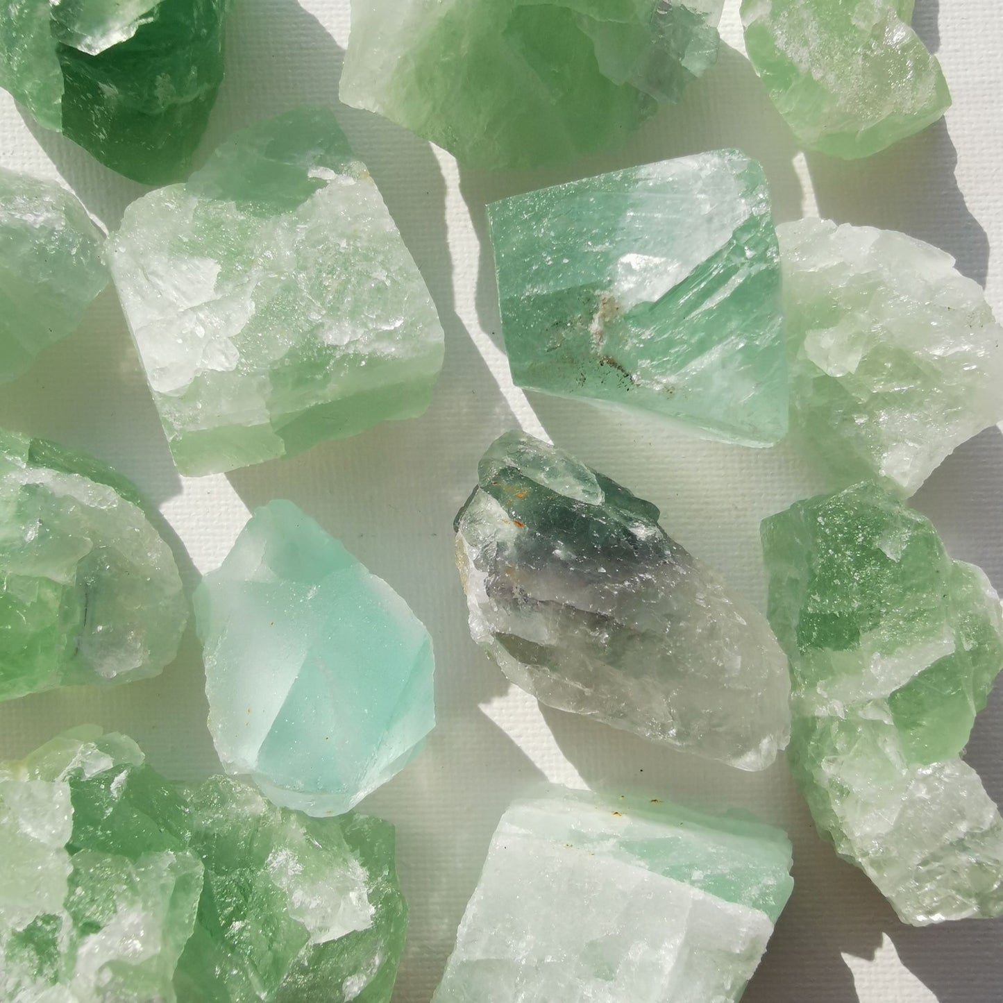 Dumi's Crystals | Rough Green Fluorite Crystals (Balance & Focus) | A collection of Rough Green Fluorite Crystals, reminders of your inner harmony. Green Fluorite fosters peace, reduces negativity & enhances focus. Scatter them in your home or workspace to create a calming environment, improve concentration & welcome holistic healing. Embrace the power of Rough Green Fluorite from Dumi's Crystals!