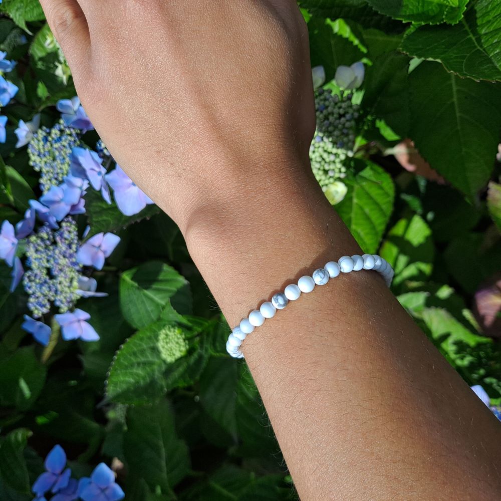  Dumi's Crystals | Howlite Stretch Bracelet (4mm beads) | Showcasing the calming serenity of Howlite on a wrist. This bracelet features genuine Howlite beads, known for their calming white color and association with Gemini & Virgo zodiac signs. Howlite promotes peace, mental clarity, and emotional balance.