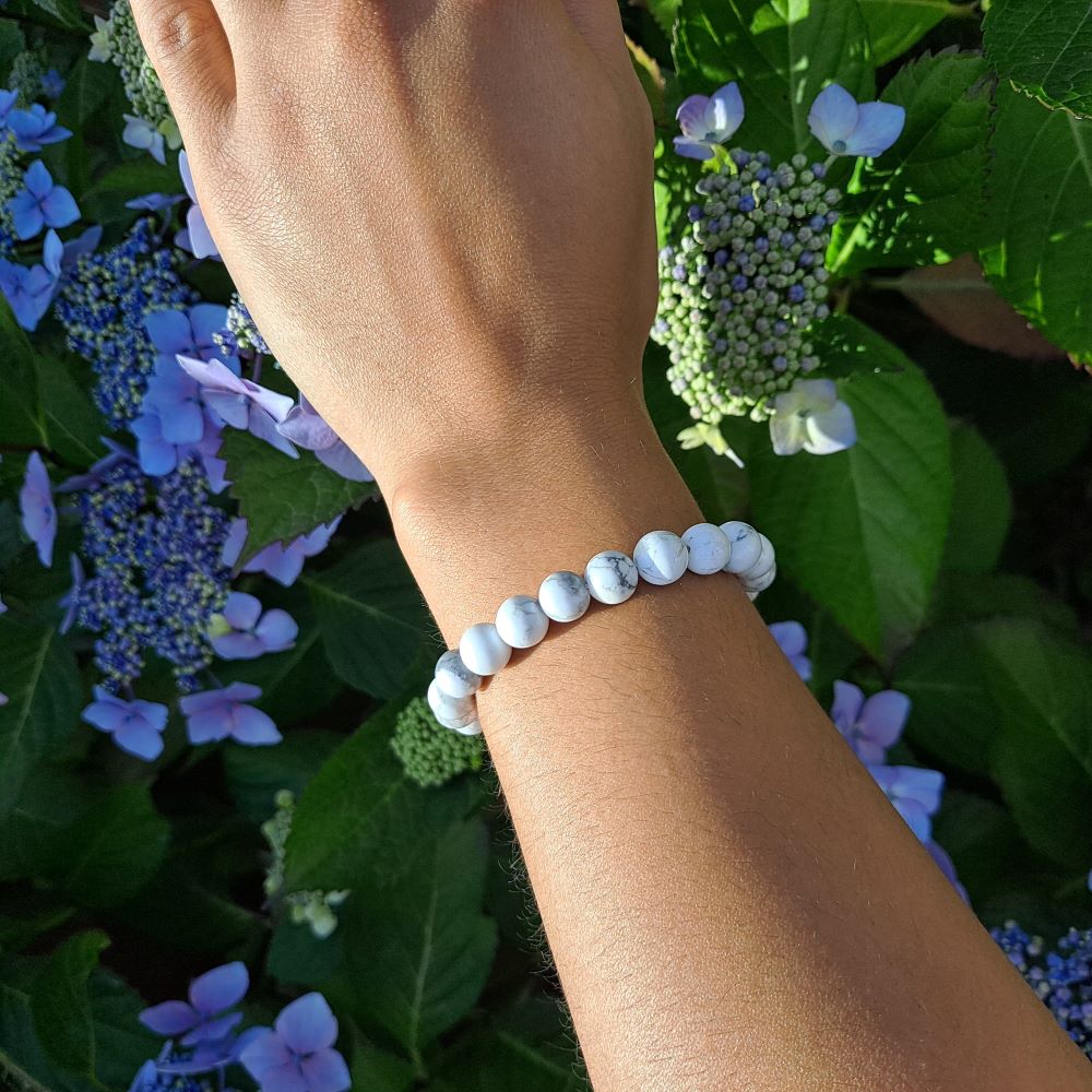White Howlite bracelet with bold beads for calming energy on wrist | Dumi's Crystals | Embrace peace in style with this Howlite stretch bracelet. Large 8mm beads, stress relief, restful sleep, and a touch of bold elegance.