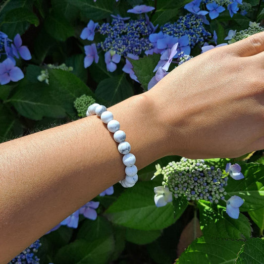 White Howlite bracelet with bold beads for calming energy on wrist | Dumi's Crystals | Embrace peace in style with this Howlite stretch bracelet. Large 8mm beads, stress relief, restful sleep, and a touch of bold elegance.