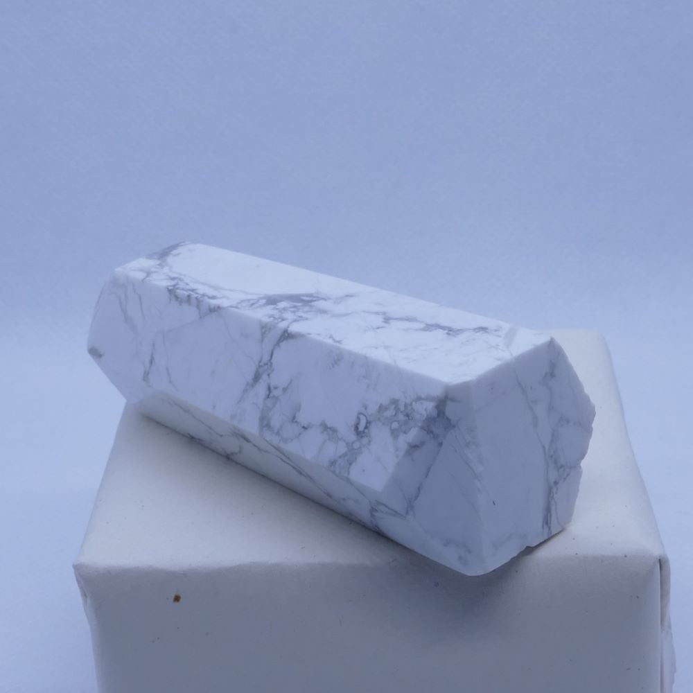 Polished Howlite Tower: Dumi's Crystals Howlite Tower, meticulously polished to a smooth finish. This calming stone promotes patience, reduces anxiety, and supports emotional balance.