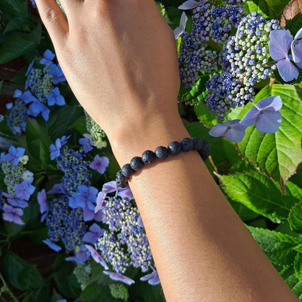Dumi's Crystals | Lava Stone Stretch Bracelet (8mm) | Showcasing the bold style and grounding energy of 8mm Lava Stone on a wrist. This bracelet doubles as an essential oil diffuser, offering aromatherapy benefits throughout the day.