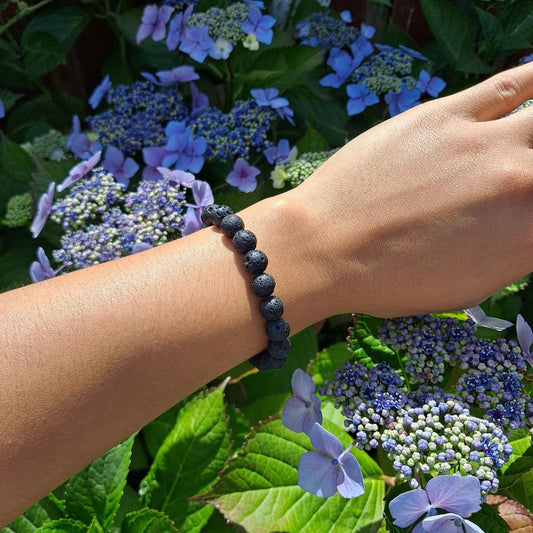 Dumi's Crystals | Lava Stone Stretch Bracelet (8mm) | Showcasing the bold style and grounding energy of 8mm Lava Stone on a wrist. This bracelet doubles as an essential oil diffuser, offering aromatherapy benefits throughout the day.