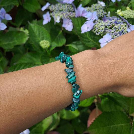 Dumi's Crystals | Malachite Stretch Bracelet | Showcasing the captivating green hues and swirling patterns of Malachite on a wrist. This bracelet is known for its transformative energy, promoting emotional healing, courage, and growth.