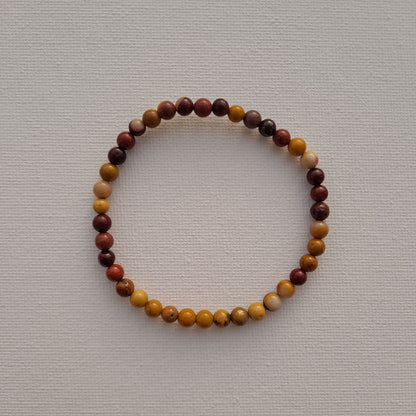 7-Inch Mookaite Jasper Bracelet (4mm Beads) | Dumi's Crystals | Delicate 4mm Mookaite Jasper beads strung on a durable stretch cord. This bracelet is believed to promote emotional balance, stability, and a sense of adventure.