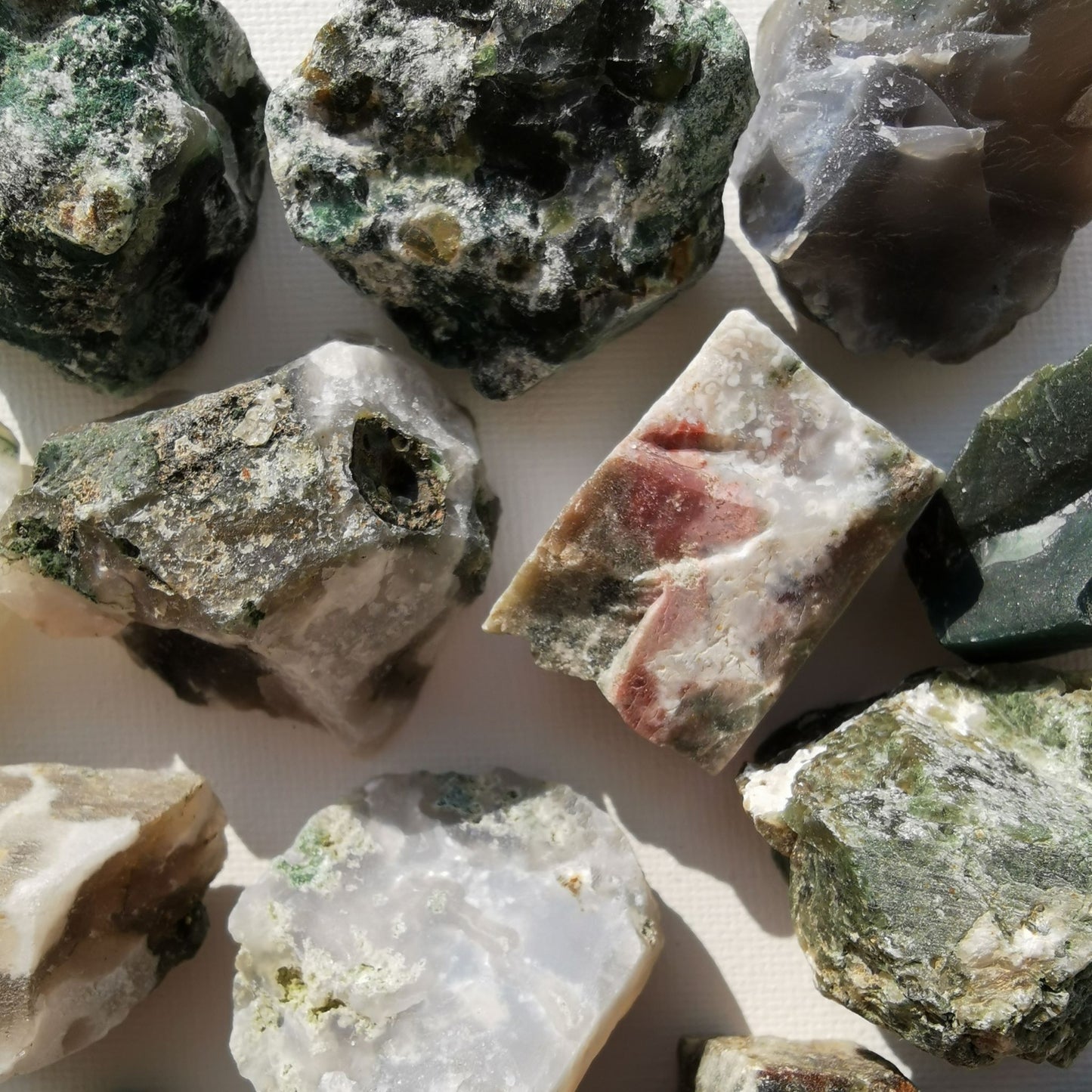 Dumi's Crystals | Rough Moss Agate Crystals (Grounding & Growth) | A collection of Rough Moss Agate Crystals, reminders of your inner peace. Moss Agate fosters calmness, reduces negativity & enhances focus. Scatter them in your home or workspace to create a tranquil environment, improve concentration & welcome spiritual growth. Embrace the power of Rough Moss Agate from Dumi's Crystals!