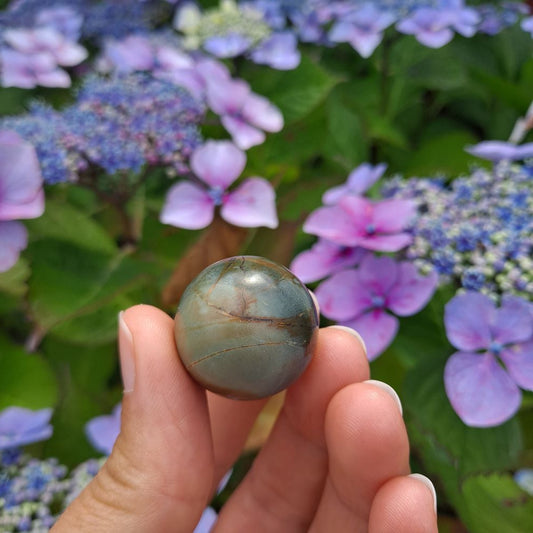 Frosted Polychrome Jasper mini sphere for peace & balance (25mm) | Dumi's Crystals | Embrace the tranquillity of Frosted Polychrome Jasper! This mini sphere (25mm) is known for fostering harmony, reducing stress, and promoting a sense of security.
