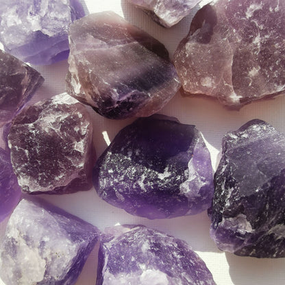 Dumi's Crystals | Rough Purple Fluorite Crystals (Peace & Insight) | A collection of Rough Purple Fluorite Crystals, reminders of your inner clarity. Purple Fluorite fosters peace, reduces negativity & enhances intuition. Scatter them in your home or workspace to create a tranquil environment, promote mental focus & welcome spiritual growth. Embrace the power of Rough Purple Fluorite from Dumi's Crystals!