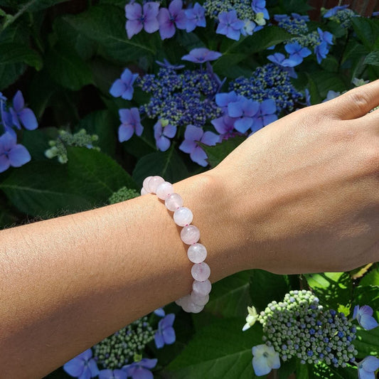  Dumi's Crystals | 8mm Rose Quartz Stretch Bracelet (7 Inch) | Showcasing the captivating beauty of 8mm Rose Quartz beads on a wrist. This bracelet promotes emotional healing, self-love, and fosters confidence. Rose Quartz, the stone of unconditional love, is known for its rich pink hues.
