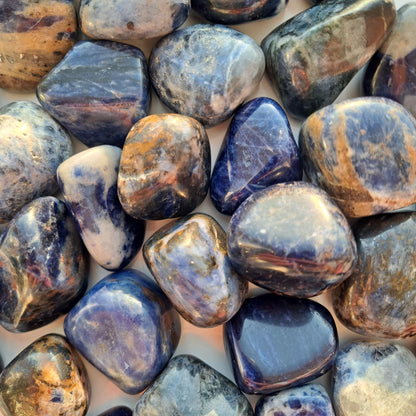 Dumi's Crystals | Sodalite Tumbled Stones (Wisdom & Growth) | A collection of Sodalite Tumbled Stones, each a testament to nature's beauty. Sodalite awakens intuition, enhances focus & reduces stress. Scatter them in your home or workspace to create a space overflowing with clarity and inspiration.