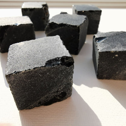 Dumi's Crystals | Square Rough Black Obsidian Crystal (Protection on-the-Go) | Embrace protection wherever you go with this Square Rough Black Obsidian. This captivating black crystal shields against negativity, grounds your energy & promotes inner strength. Carry it in your pocket or meditate with it for emotional healing & self-discovery. Ethically sourced by Dumi's Crystals.